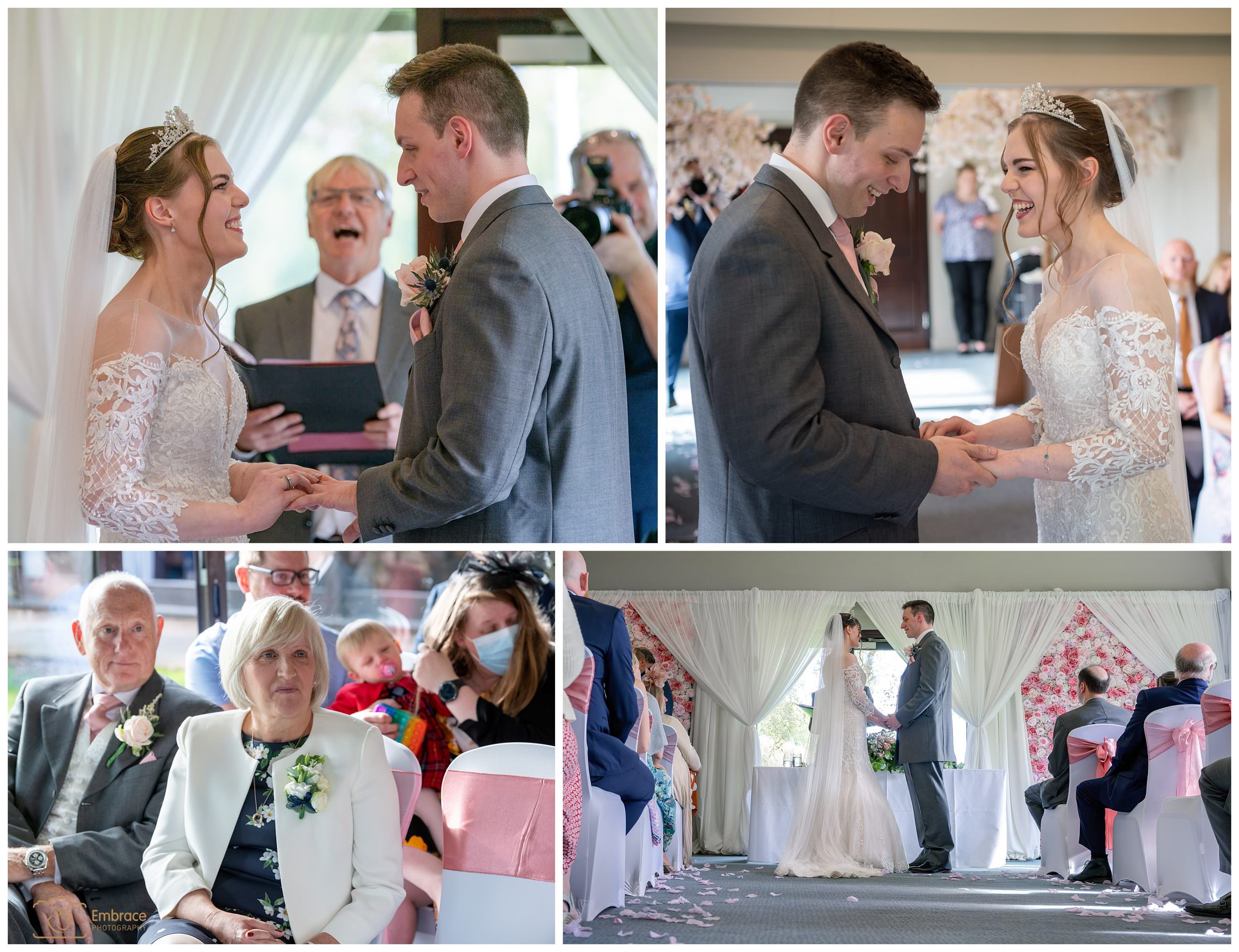 Bride putting the ring on the grooms finger during wedding ceremony at Barnham Broom
